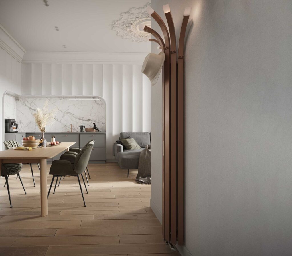 Designerski grzejnik ENIX Palm w odcieniu brązu lub miedzi, z powieszonym na nim kapeluszem, w nowoczesnym, minimalistycznym holu Grzejnik z wieszakami: Palm nie tylko ogrzewa, ale pełni również rolę stylowego wieszaka na ubrania, idealnie pasującego do przedpokoju.